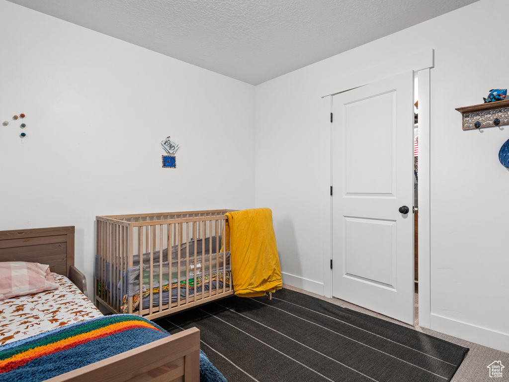 Bedroom with dark colored carpet