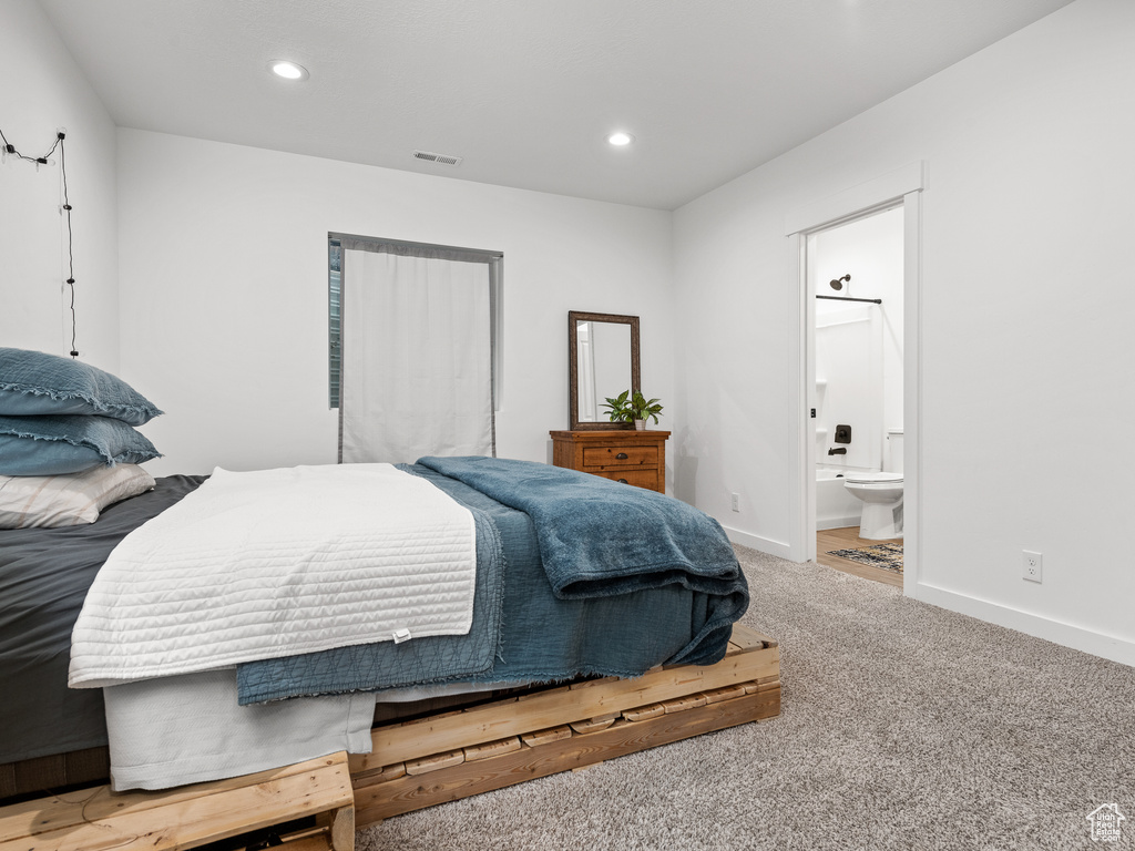 Bedroom featuring carpet flooring, recessed lighting, and ensuite bathroom