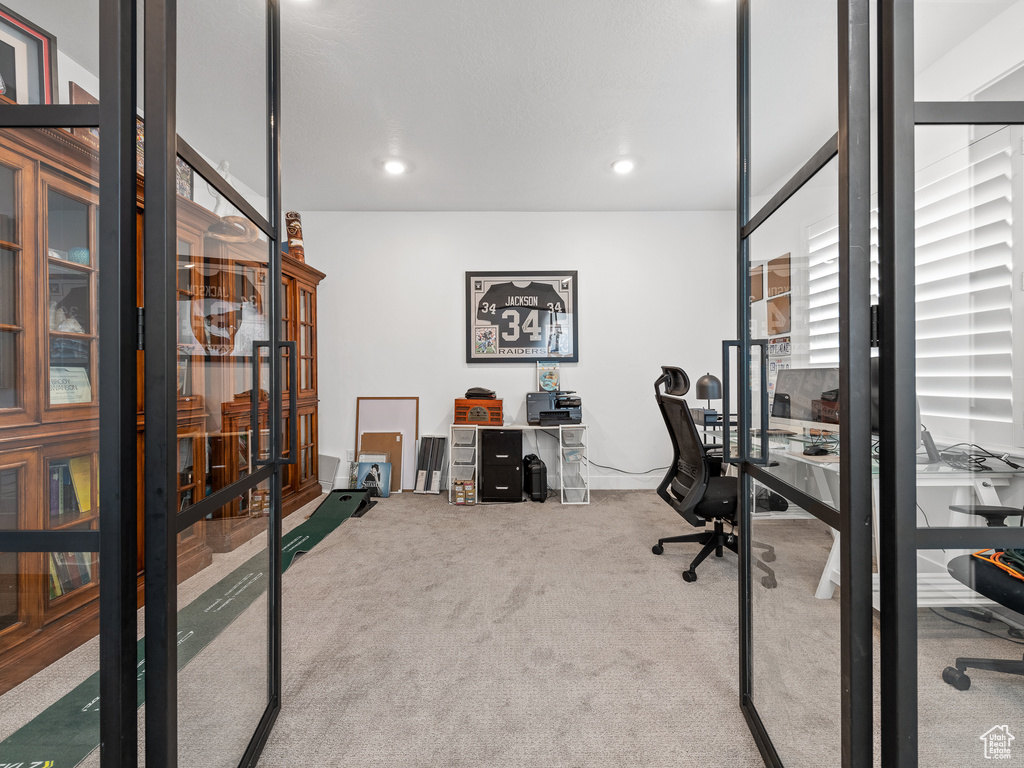 Carpeted home office featuring recessed lighting