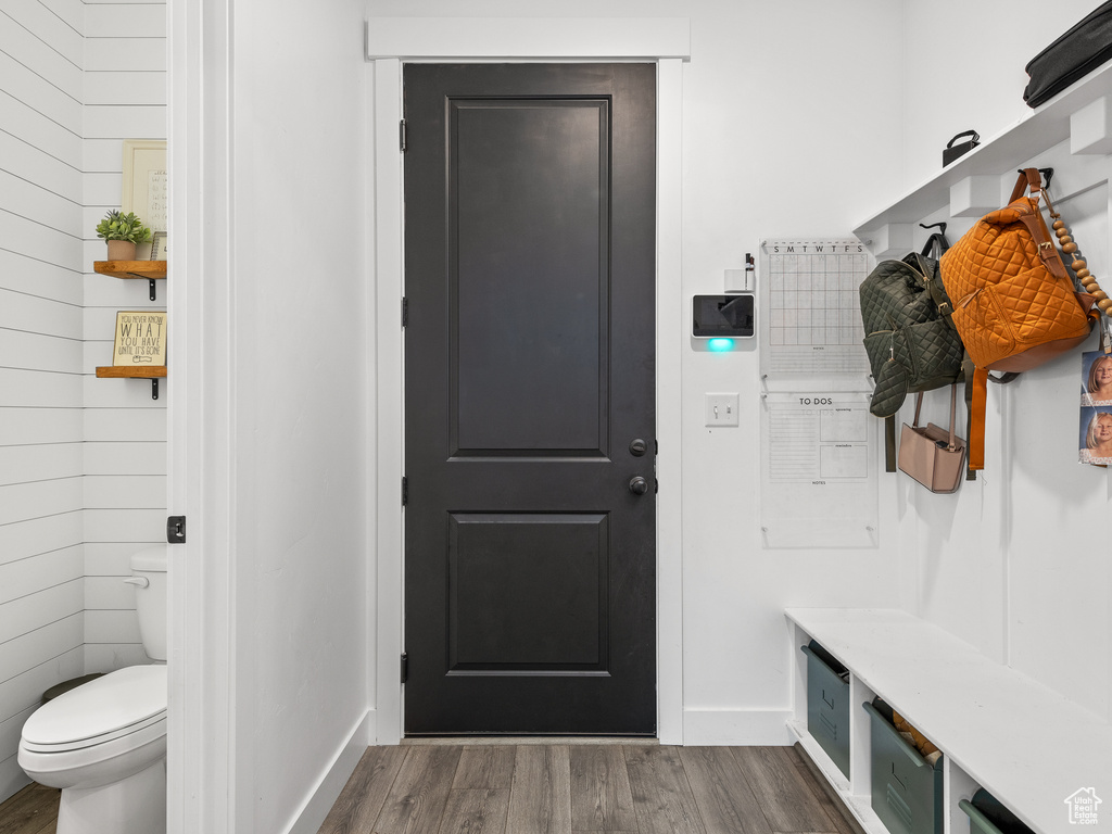 Mudroom featuring dark wood-style flooring and baseboards