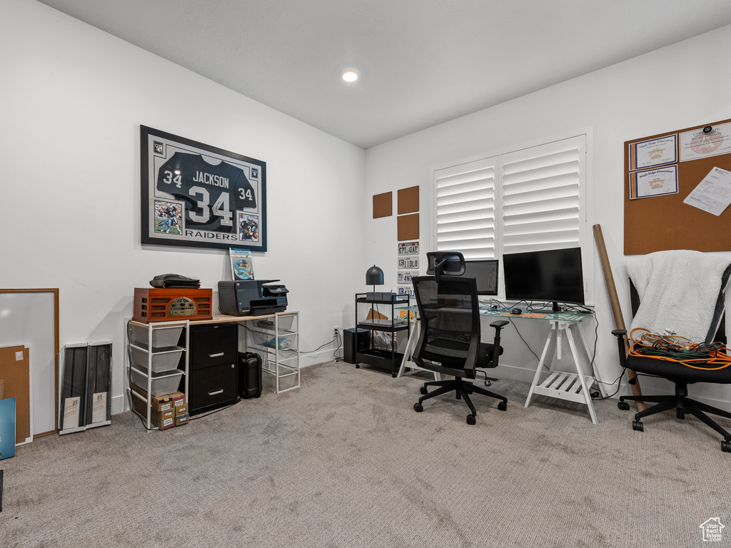 Office with carpet flooring and recessed lighting