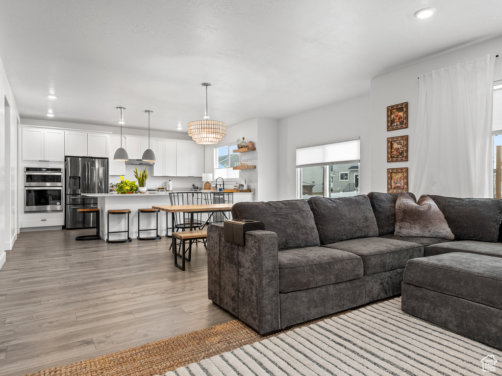 Living area featuring light wood-type flooring and recessed lighting