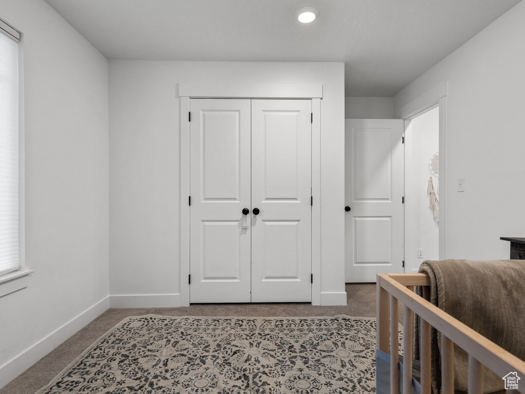 Carpeted bedroom with a closet and recessed lighting