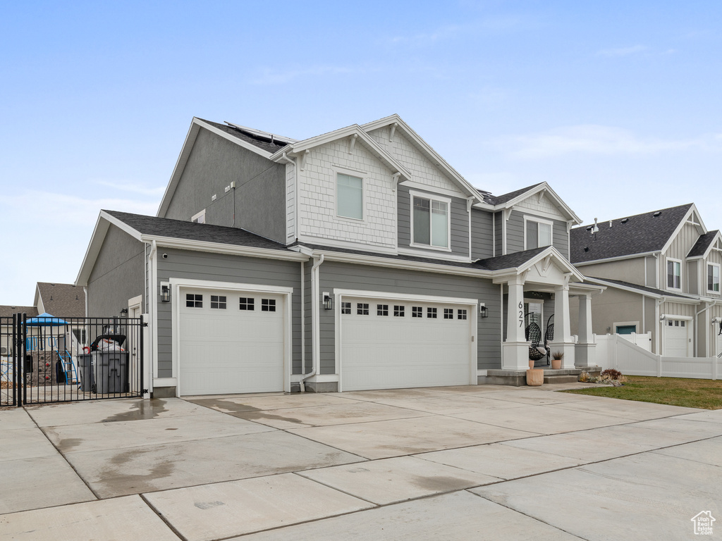 View of front facade featuring driveway and a garage