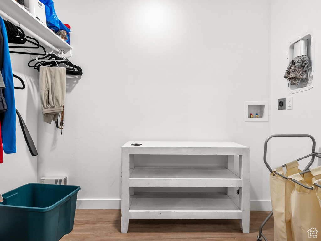 Washroom featuring electric dryer hookup, wood finished floors, and washer hookup