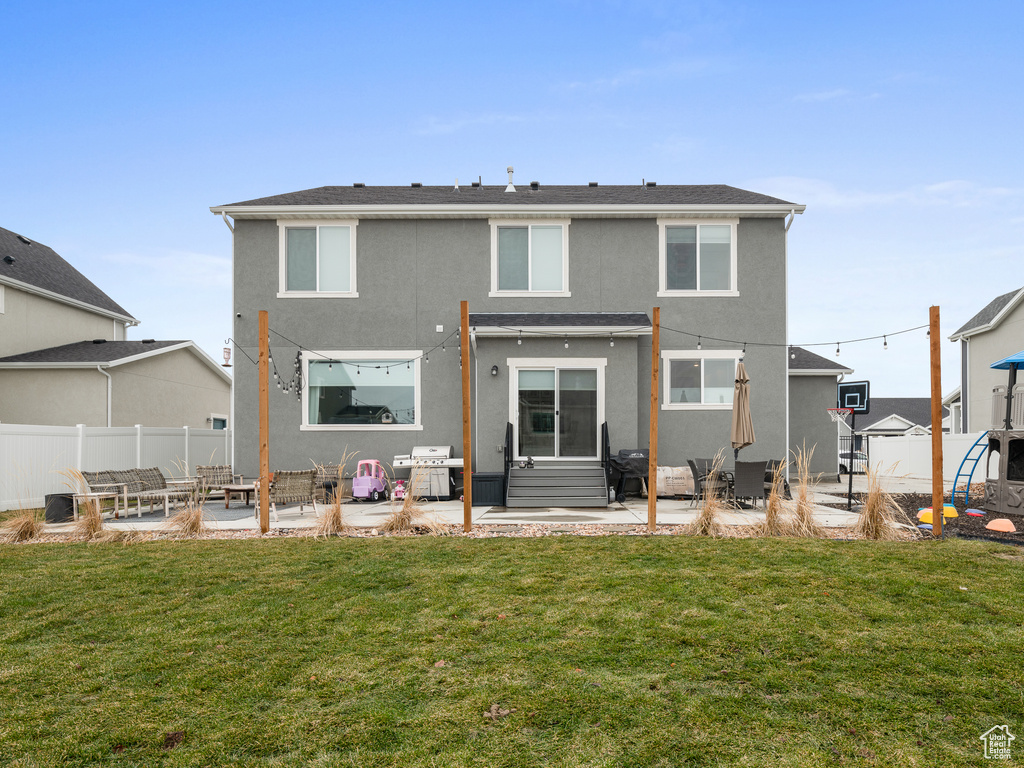 Rear view of property featuring an outdoor living space, stucco siding, and a patio area