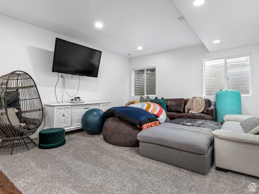 Carpeted living area with recessed lighting