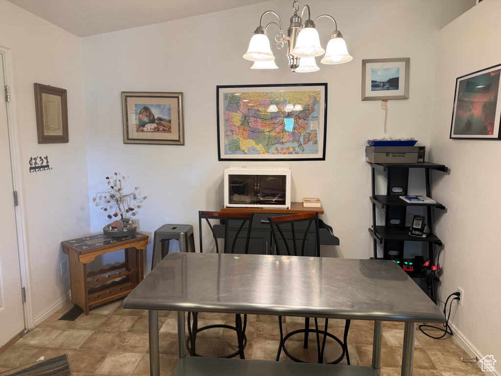 Dining area featuring a chandelier and a desk