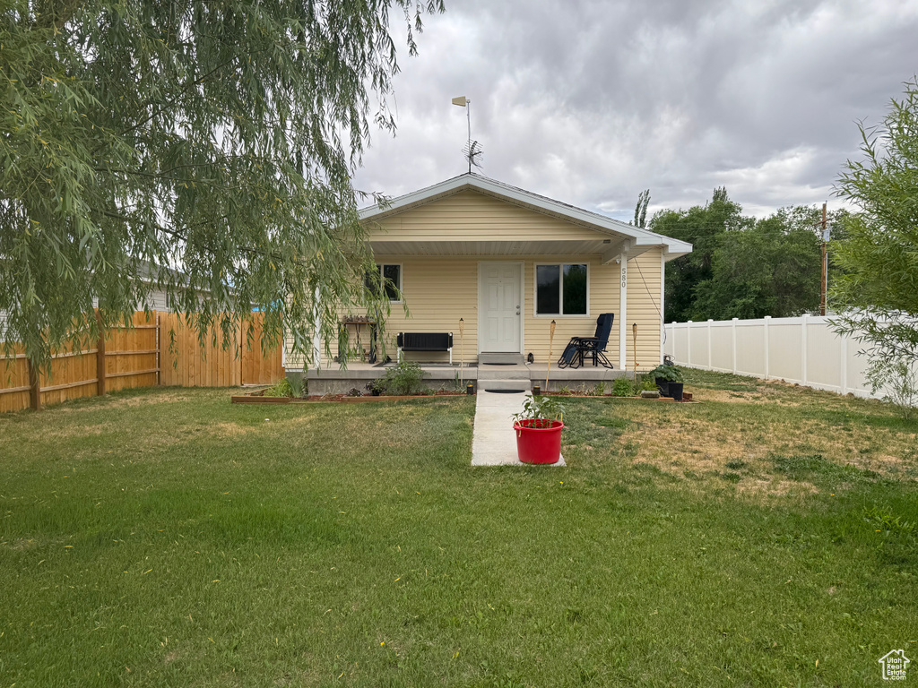 Rear view of house with a fenced backyard