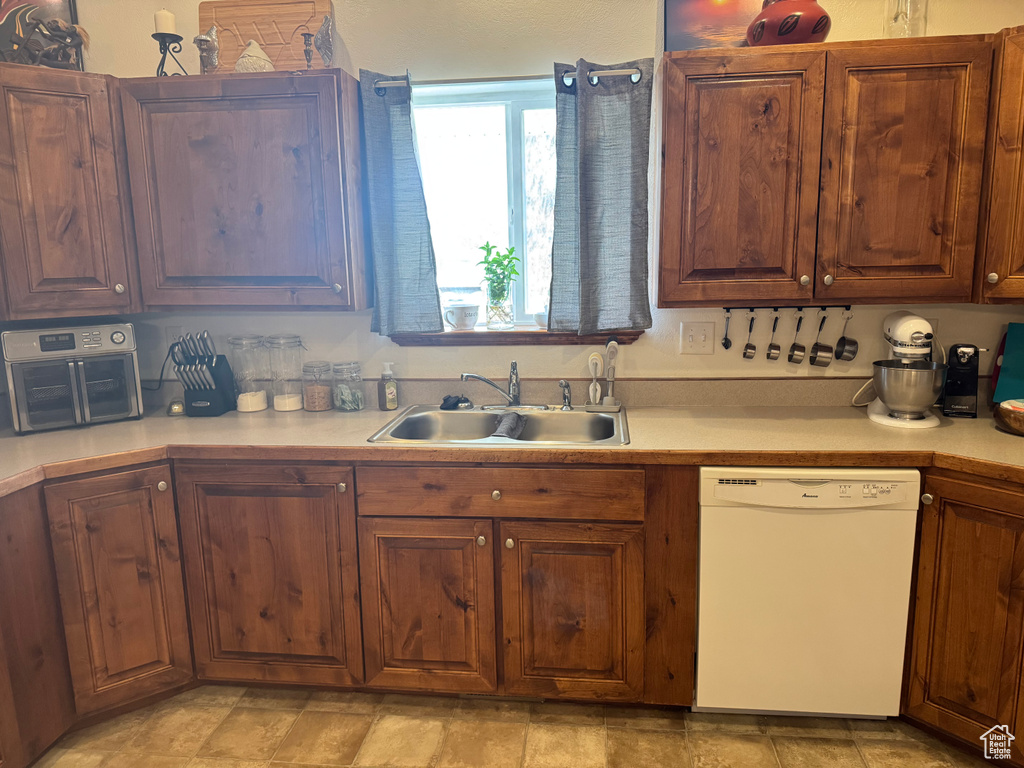 Kitchen featuring dishwasher and light countertops