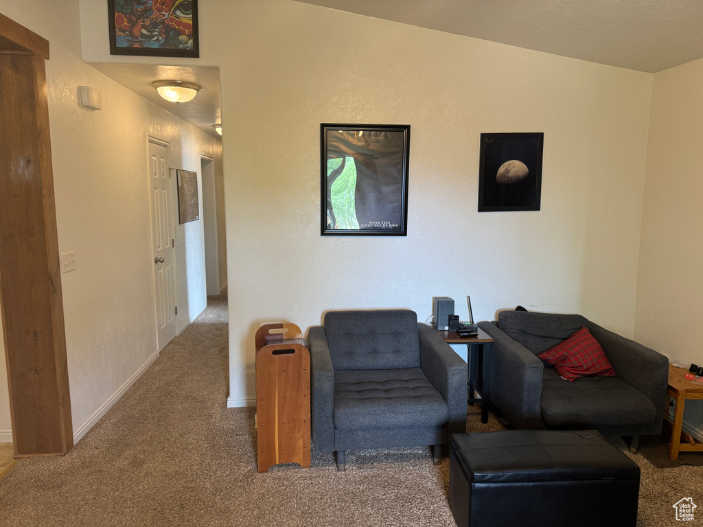 Sitting room with carpet and baseboards