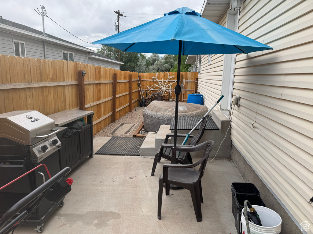 Fenced backyard featuring area for grilling and a patio area
