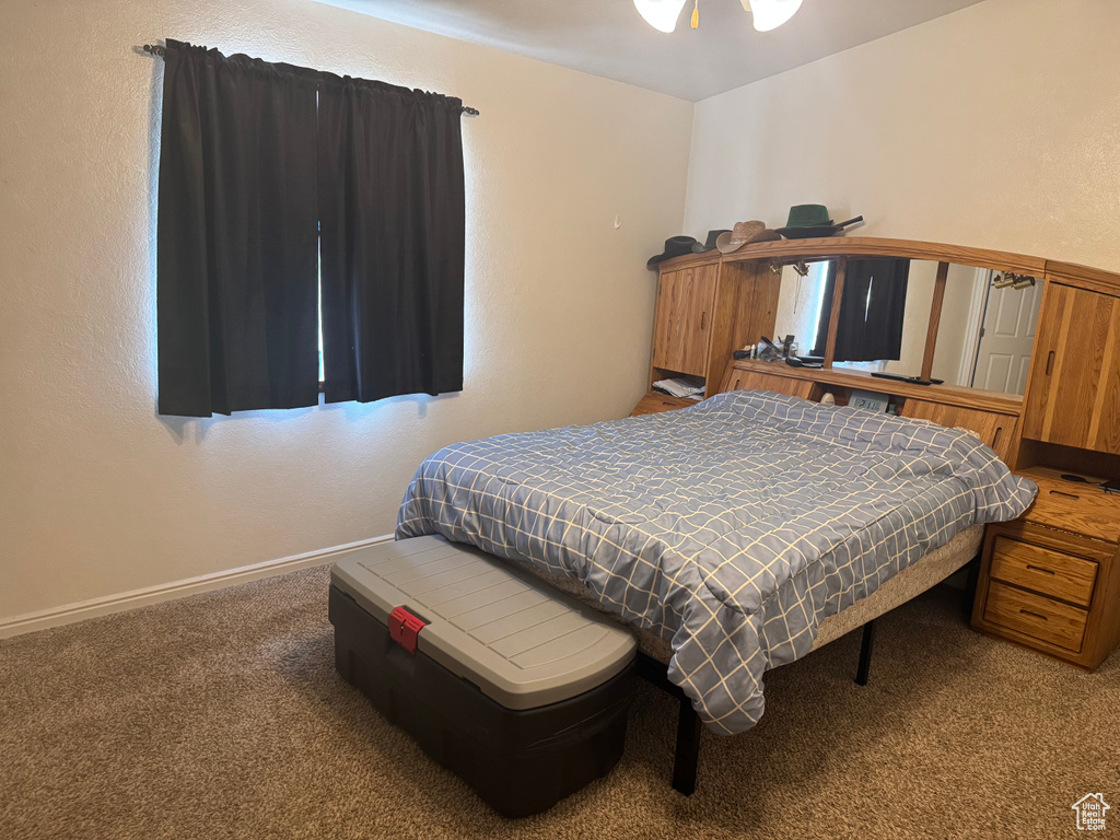 Carpeted bedroom featuring baseboards