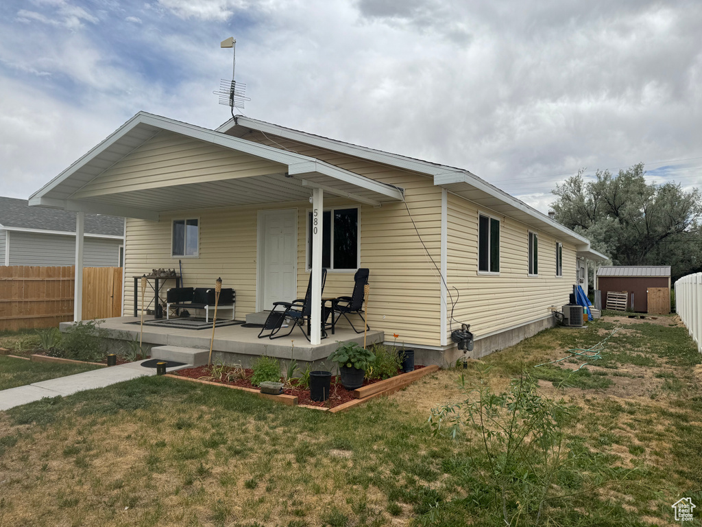 Rear view of property with a storage shed