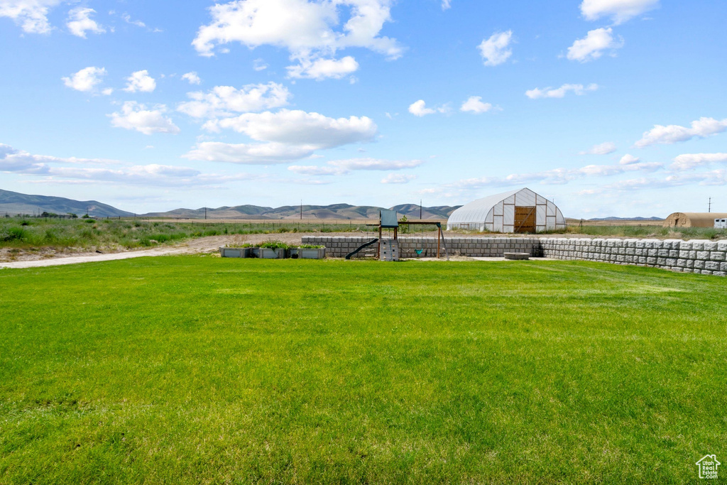 View of yard featuring an outbuilding, a mountain view, and a rural view