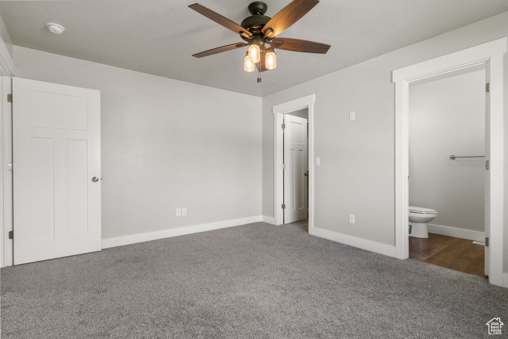 Unfurnished bedroom with carpet floors, ensuite bath, and ceiling fan