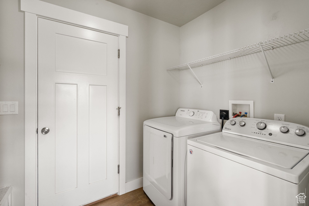 Laundry area featuring washer and clothes dryer and dark wood-style floors