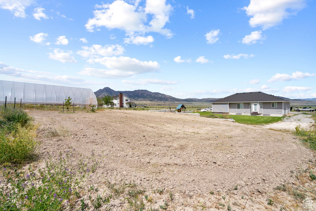 View of yard featuring a mountain view and a greenhouse