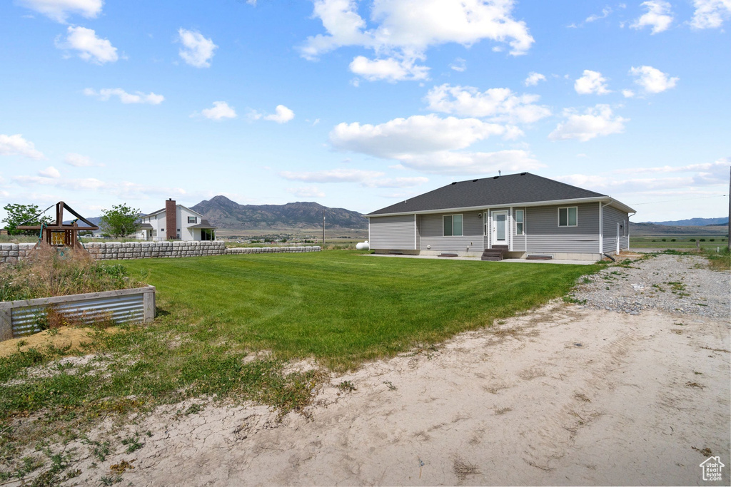 Back of property featuring entry steps and a mountain view