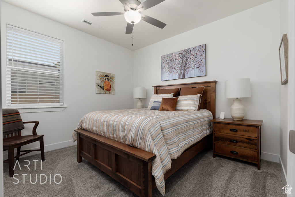 Carpeted bedroom featuring baseboards and a ceiling fan