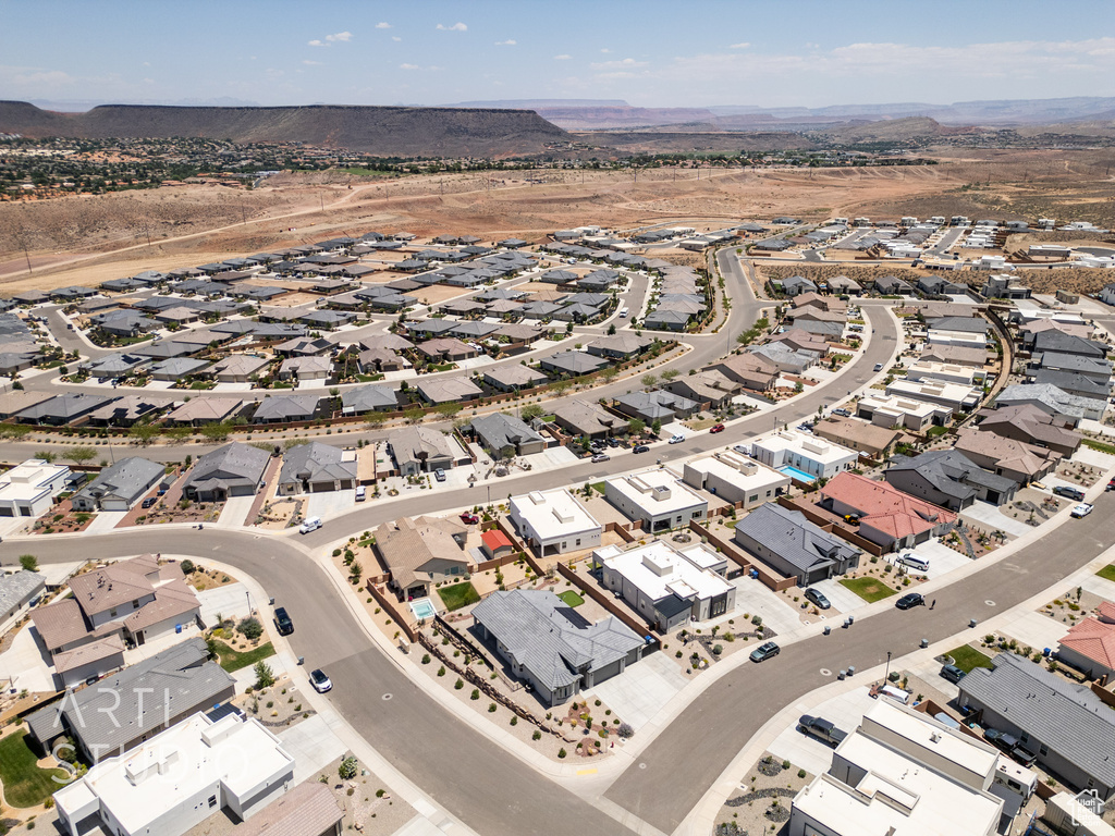 Aerial view of property's location with nearby suburban area and mountains