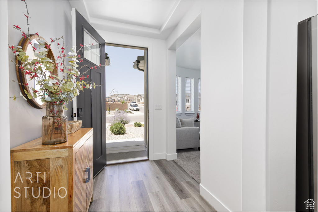Entrance foyer with light wood-type flooring and baseboards