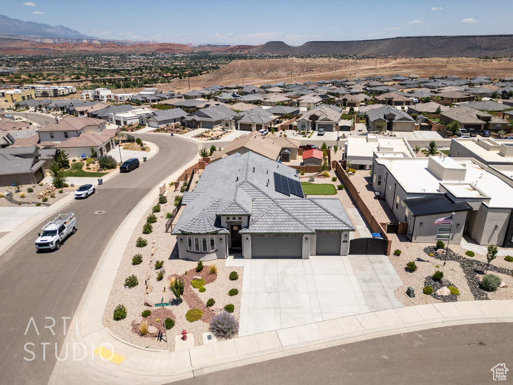 Aerial view of residential area featuring a mountainous background