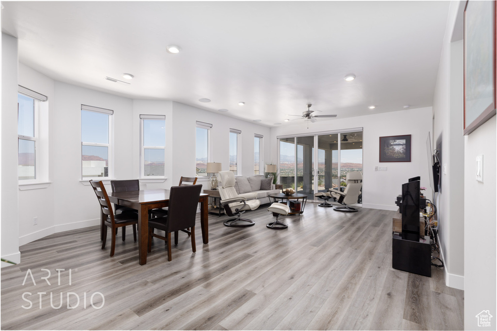 Dining space featuring light wood-style flooring, ceiling fan, and recessed lighting