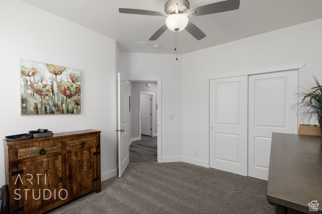 Carpeted bedroom featuring a closet and a ceiling fan