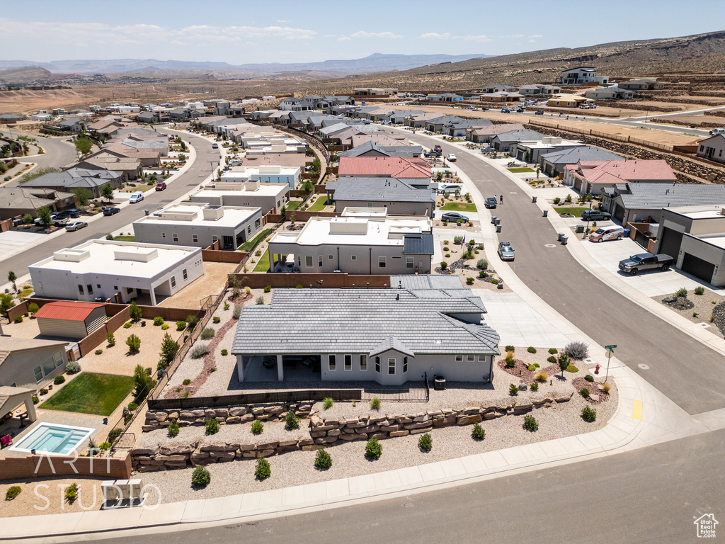 Aerial view of residential area featuring a mountainous background