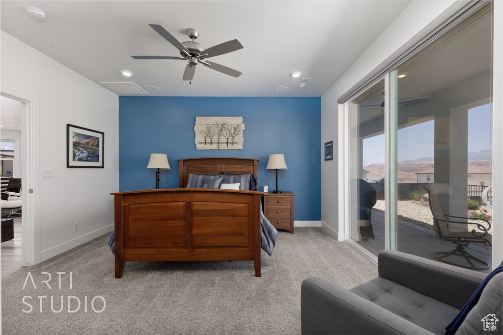 Bedroom with access to exterior, light colored carpet, multiple windows, and recessed lighting