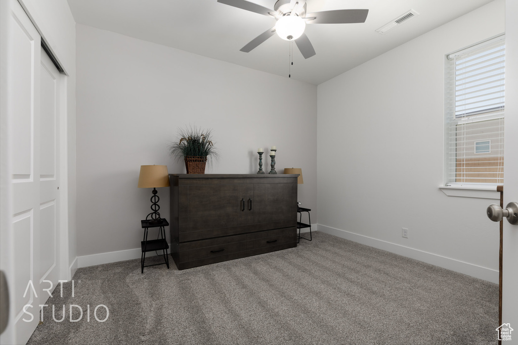 Bedroom featuring carpet, a closet, and a ceiling fan