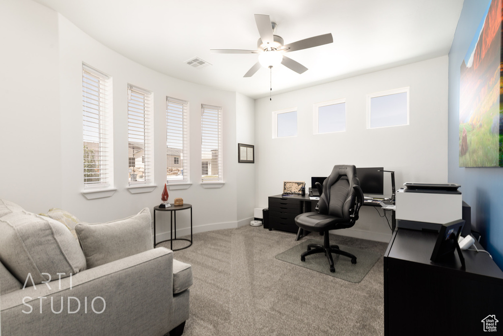 Office space with ceiling fan and carpet