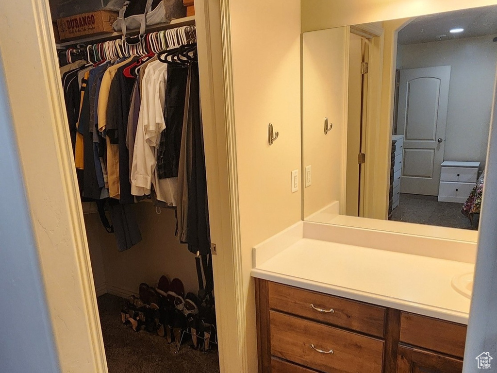 Bathroom featuring vanity and a spacious closet