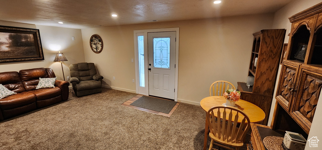 Carpeted living room featuring recessed lighting and baseboards
