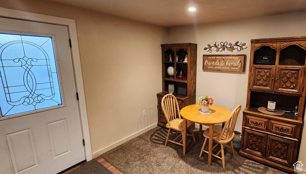 Carpeted dining area with baseboards