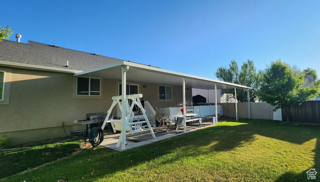 Rear view of property with stucco siding and a patio area