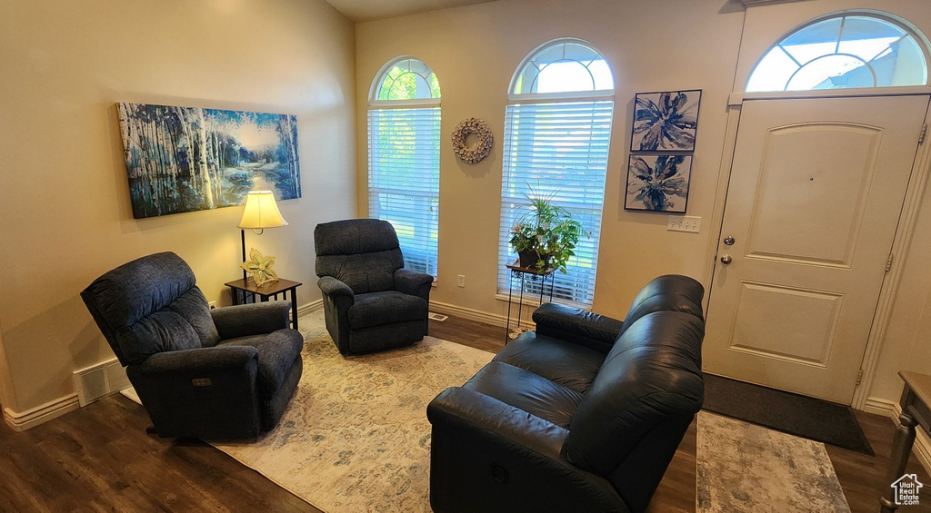 Living area with wood finished floors and baseboards