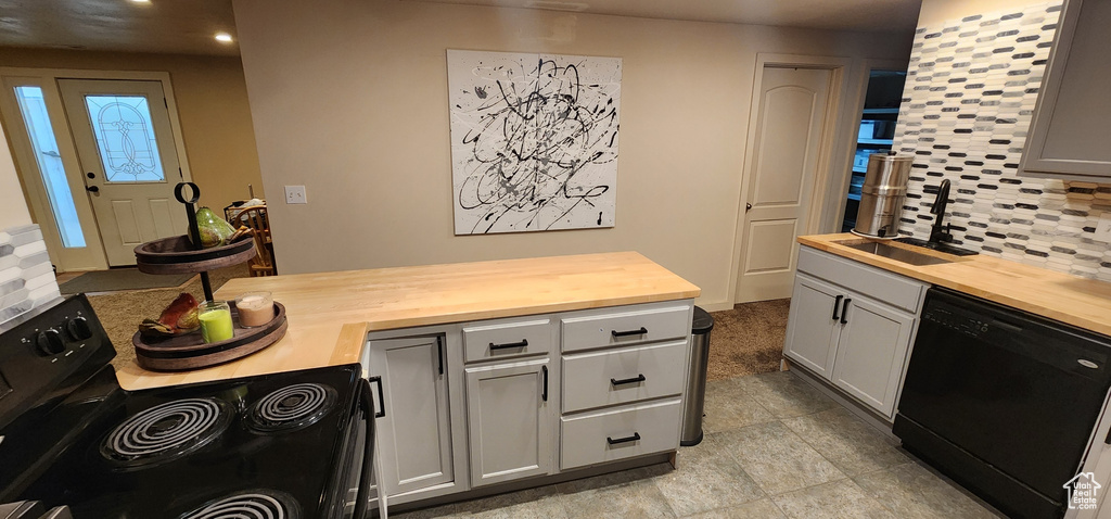 Kitchen with wooden counters, black appliances, tasteful backsplash, recessed lighting, and gray cabinets