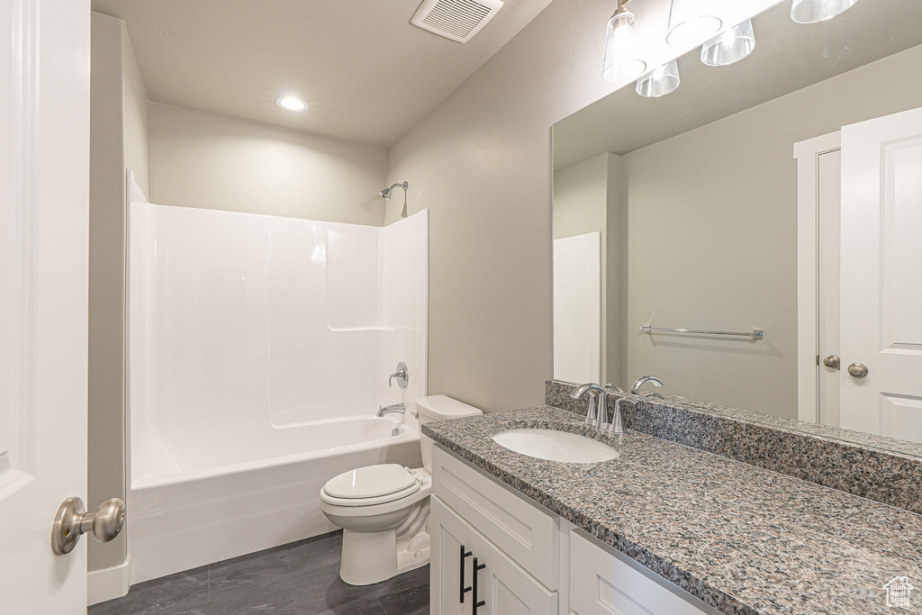 Bathroom with vanity, bathtub / shower combination, wood finished floors, and recessed lighting