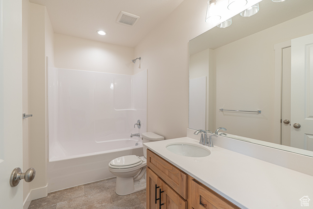 Bathroom featuring vanity, shower / tub combination, and recessed lighting