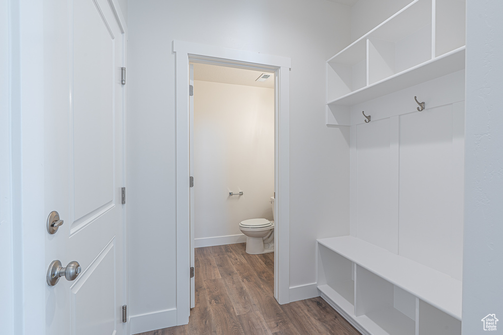 Mudroom with dark wood-style flooring and baseboards