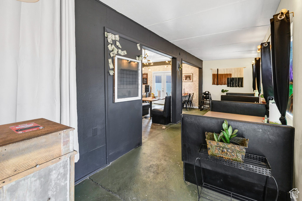 Living room with finished concrete floors and a chandelier
