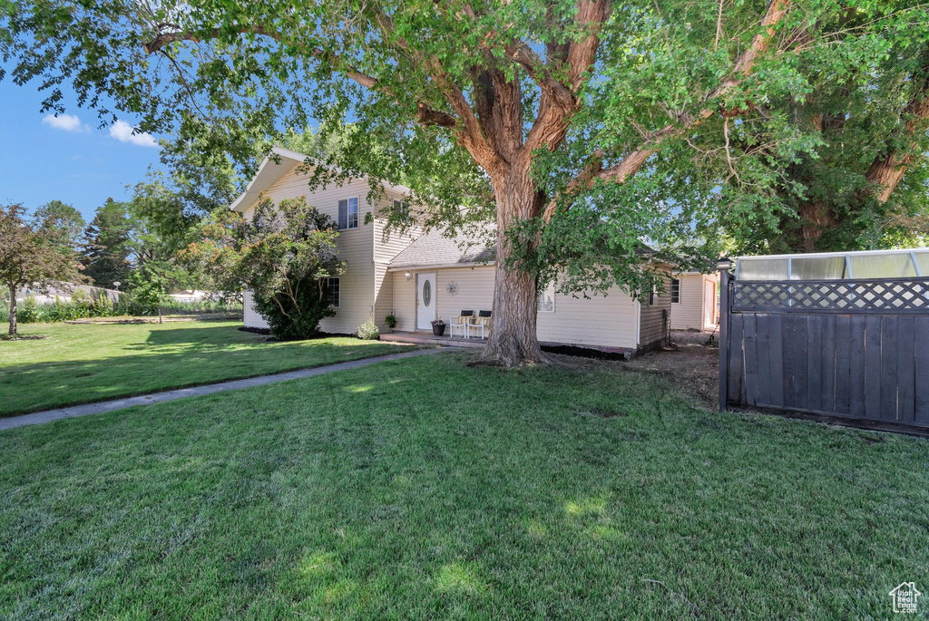 View of grassy yard with a patio
