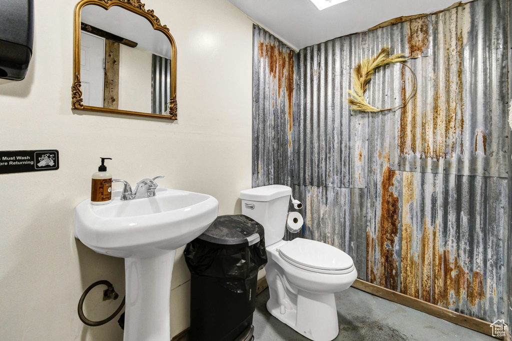 Bathroom with concrete flooring and toilet