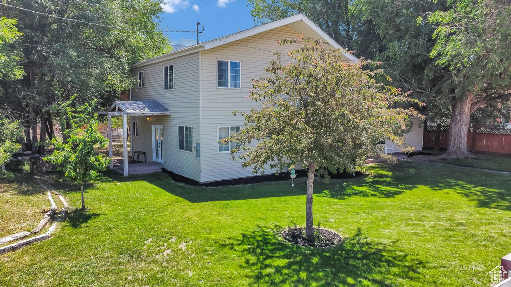 Rear view of property featuring a yard