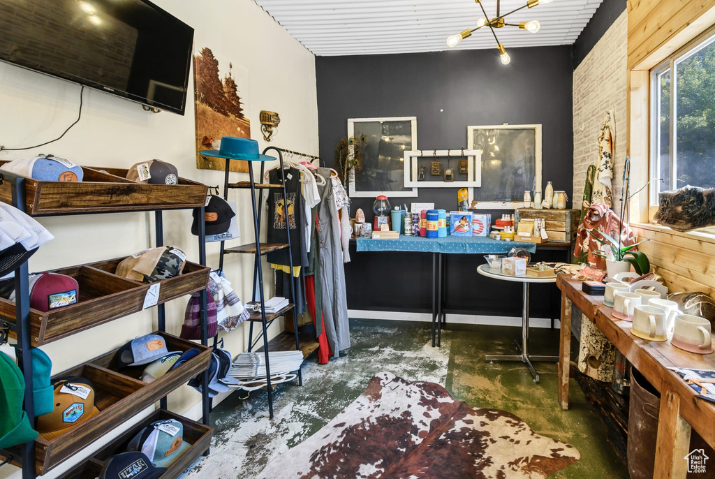 Office with concrete floors and a chandelier