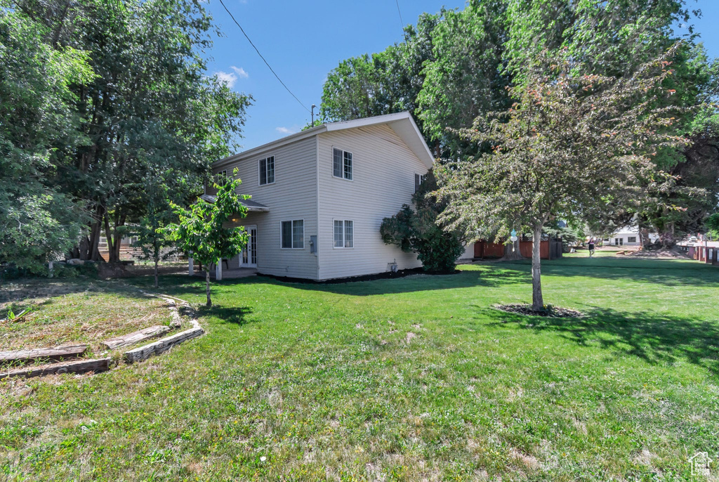View of side of property featuring a lawn