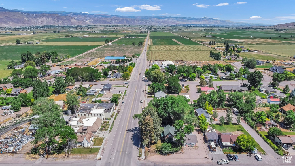 Aerial view of property and surrounding area with mountains and rural landscape