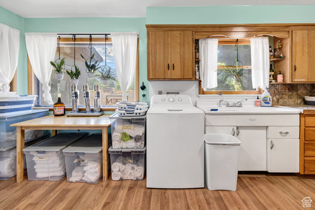 Washroom with washer / clothes dryer and light wood-type flooring